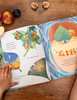 Book spread on wooden table with fruits
