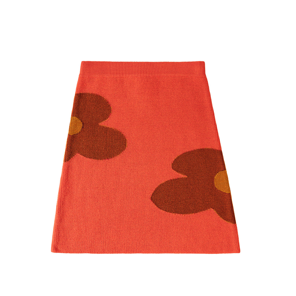 Red skirt with brown floral patterns on a white background