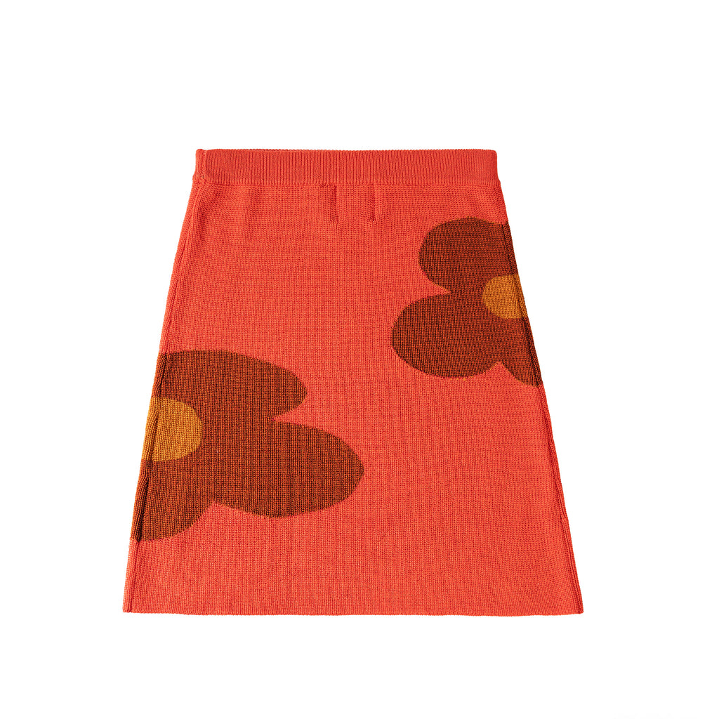 Red skirt with brown floral patterns on a white background