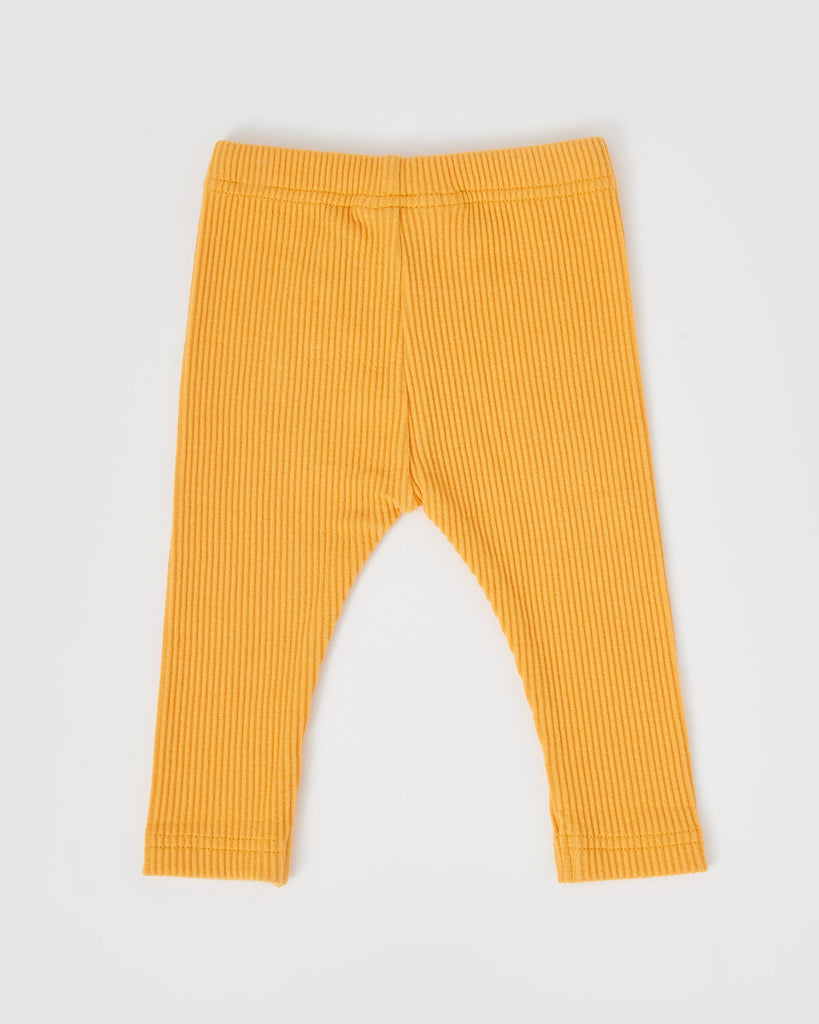 Yellow ribbed leggings on a light gray background