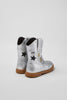 silver cowboy boot with gold and black stars on grey background.