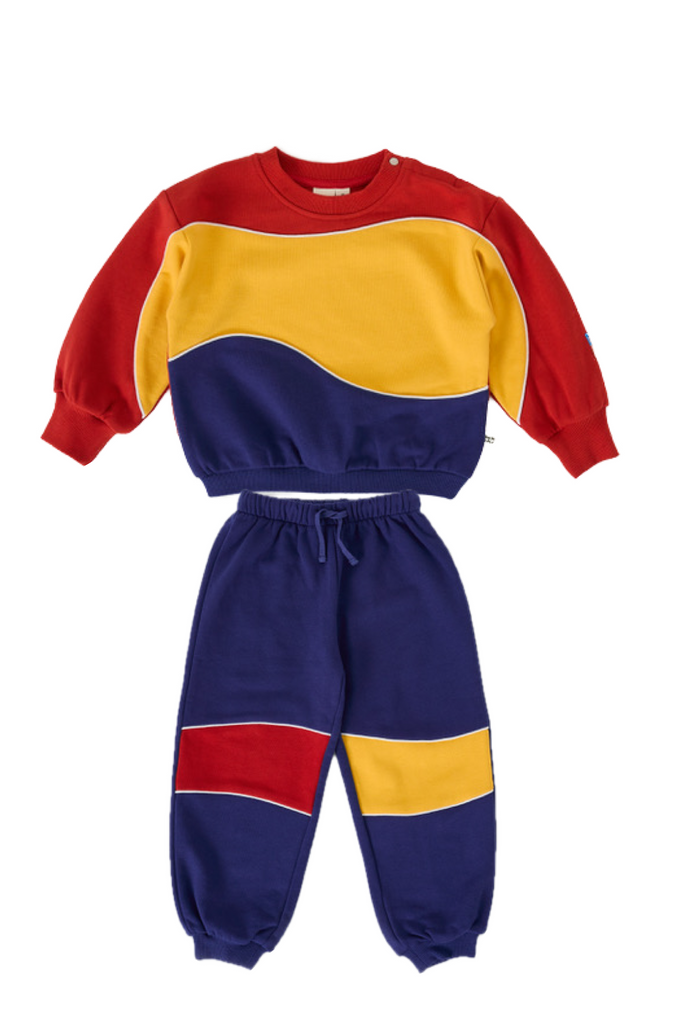 Colorful sweatshirt and pants set with red, yellow, and blue colors on a white background.